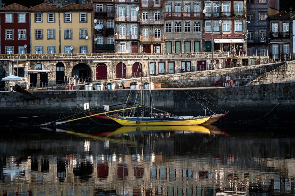 river with boat and buildings on river edge in how many days in porto portugal