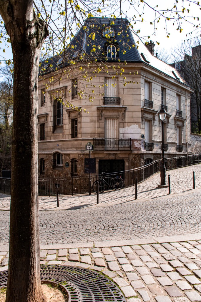 cobblestone street called rue de l'abreuvoir with building and bike