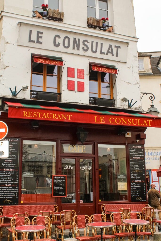cafe with red awning and table and chairs near rue de labreuvoir