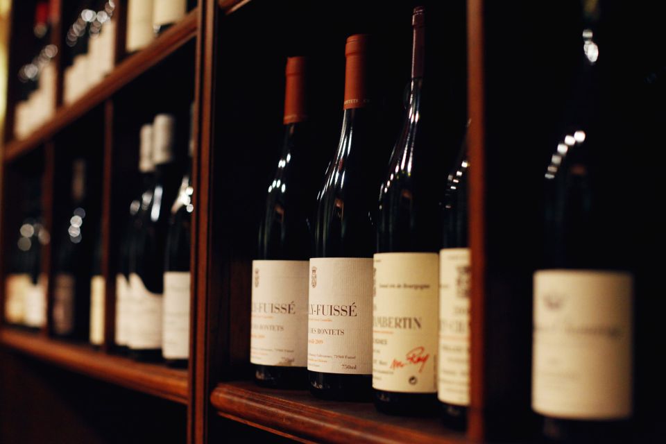 bottles of wine on shelf for wine tastings paris