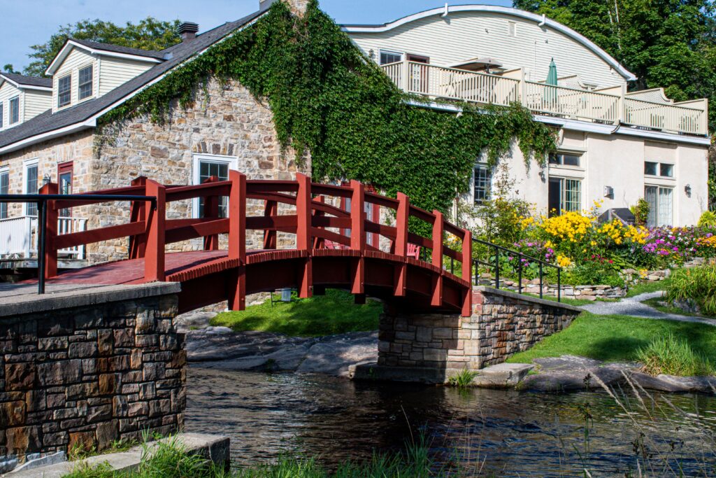 red bridge over river and stone house in what to do in perth ontario