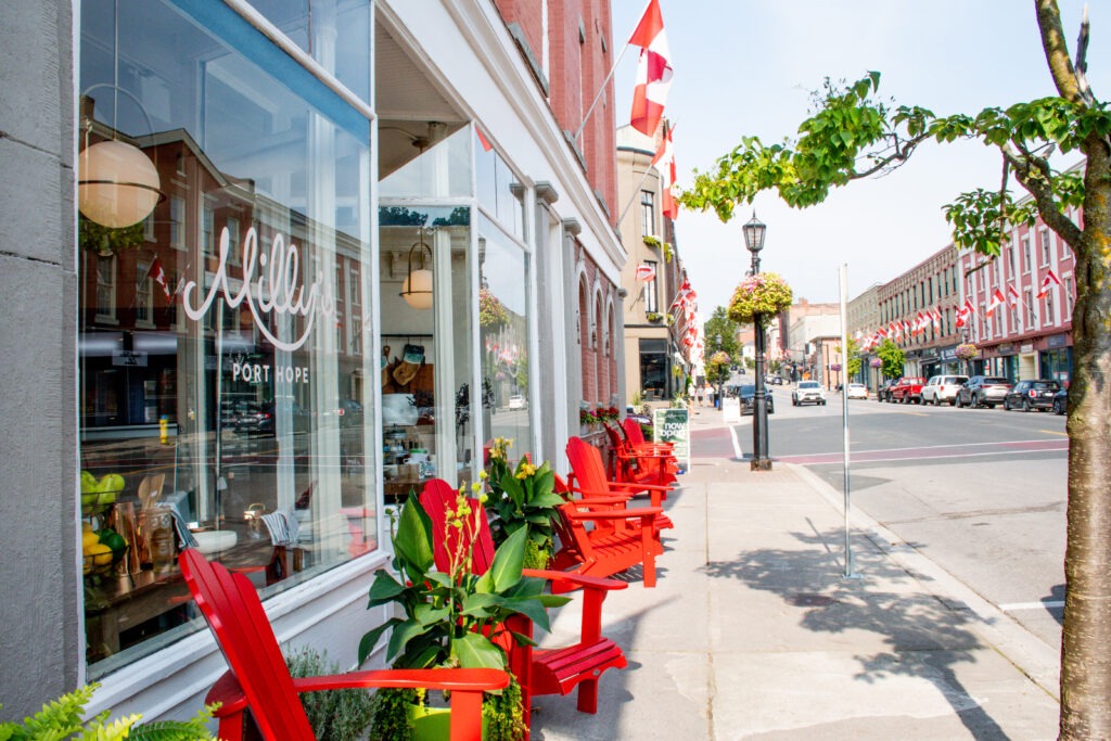 red muskoka chair and store front in beautiful small towns in ontario