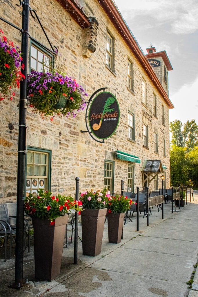 stone building with planters in perth ontario