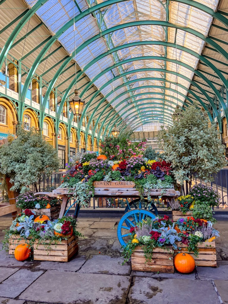 tall glass roof in market with flowers on london private tours