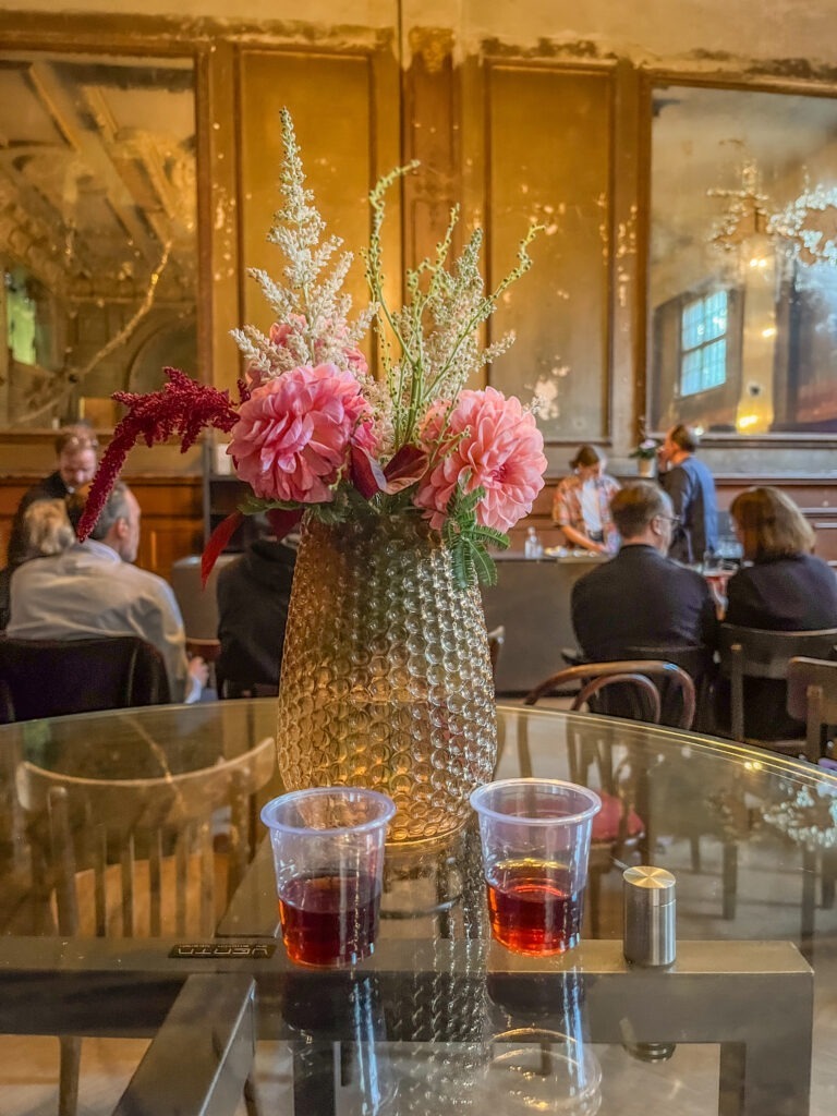 table with 2 shots of liquor in mirrored ballroom in best german restaurant berlin