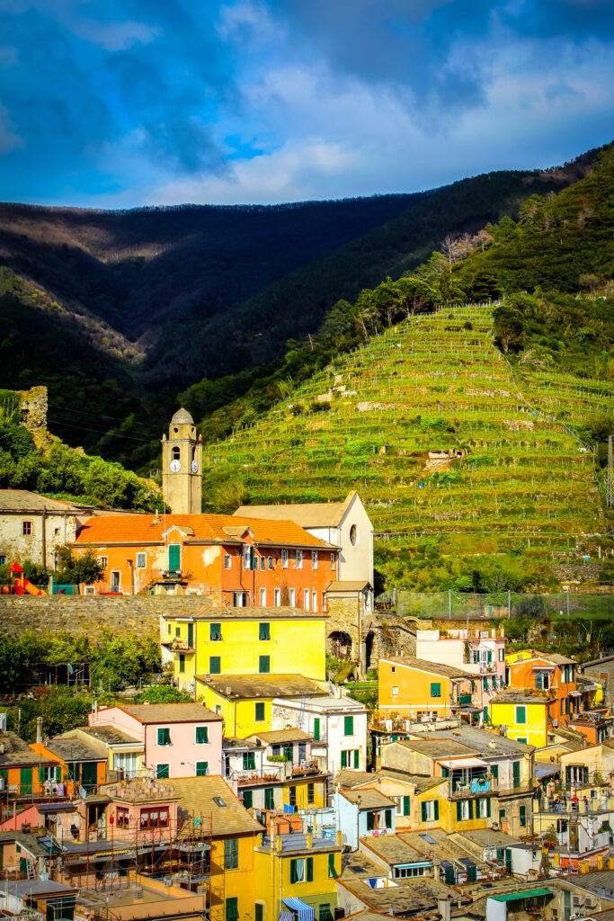 colourful village with clock tower on cinque terre tour from florence