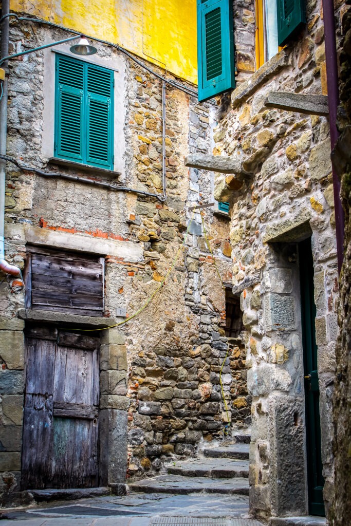 stone building with steps and green shutters on florence to cinque terre day trip