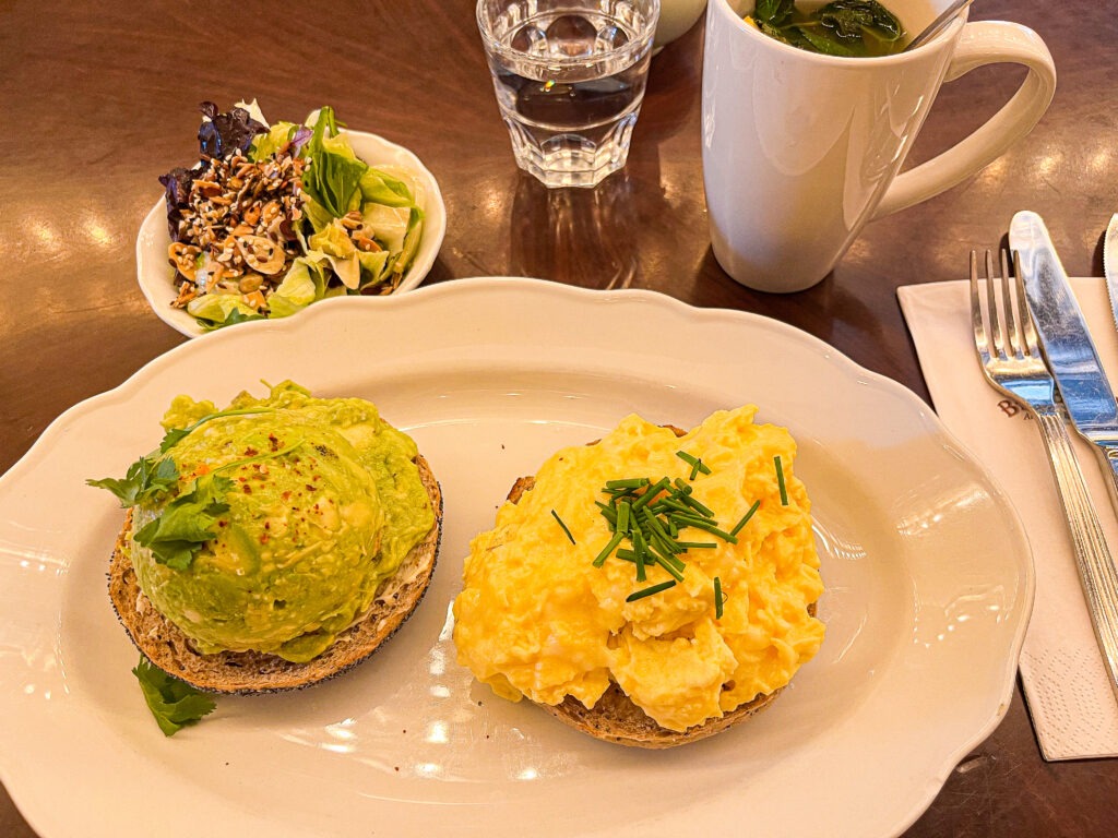 plate of egg and avocado on bagel at english breakfast berlin restaurant