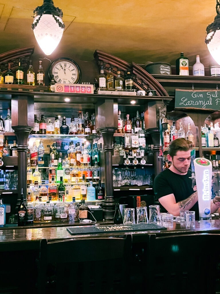 bar with liquor and bartendar pouring beer at pub serving english breakfast in berlin