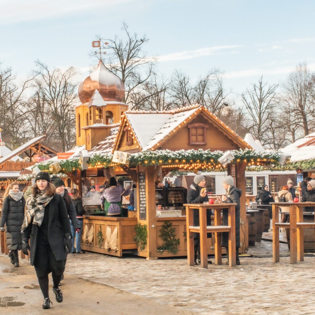 at a berlin christmas market with people, with food stall