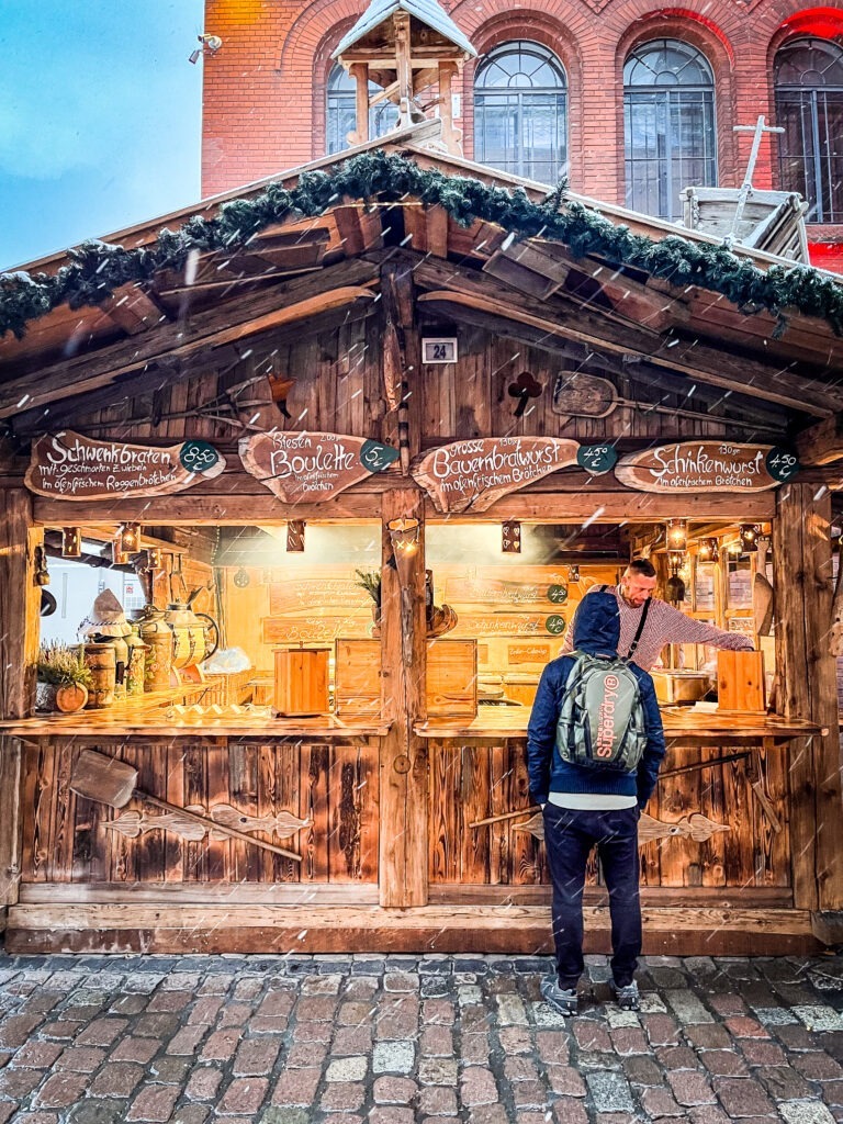 at a christmas market in berlin at food stall with person