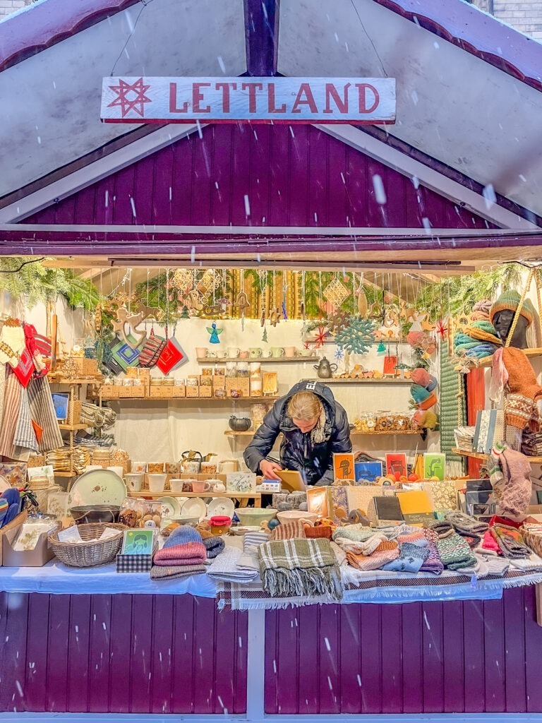 at berlin's christmas market in purple with knits with gifts
