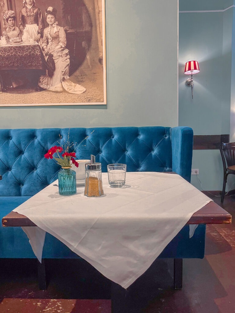 blue suede sofa with dining table at berlin breakfast places to eat