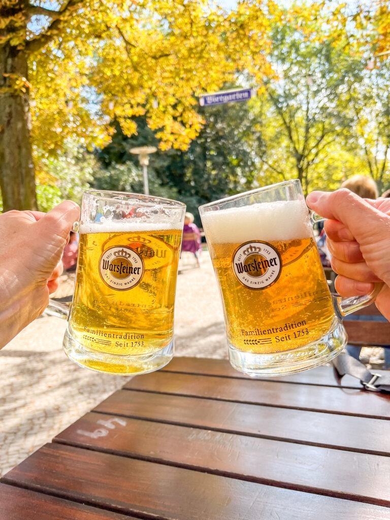 two beer steins clicking when visiting berlin germany