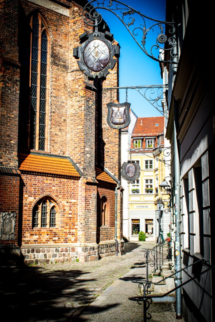 Is Berlin Worth Visiting? Not What You Expect 7 church with iron signs that resemble medieval times in a small Berlin neighbourhood