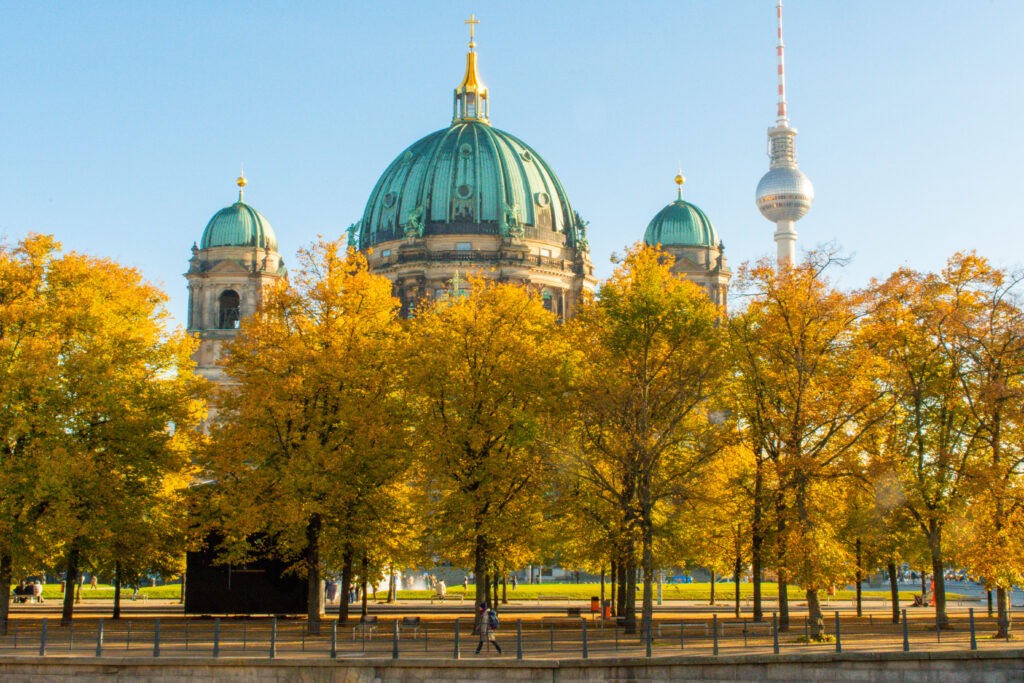yellow linden trees in fall with berlin cathedral and tv tower from unter den linden berlin germany