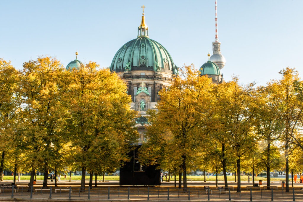 yellow linden trees in fall with berlin cathedral and tv tower from unter den linden berlin germany
