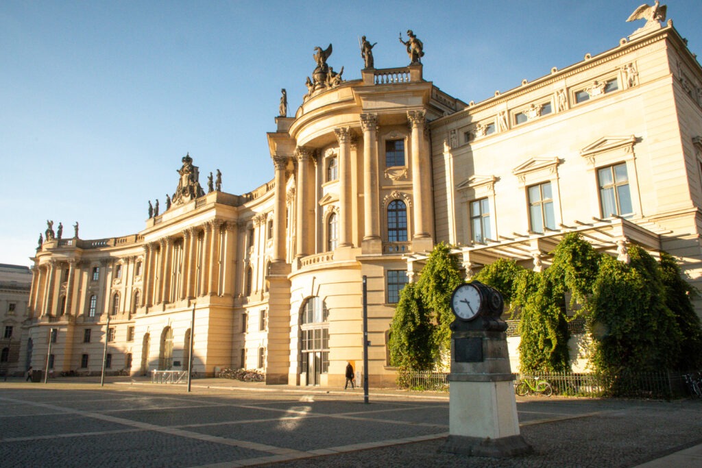 large palace with statues and clock on square on unter den linden berlin 