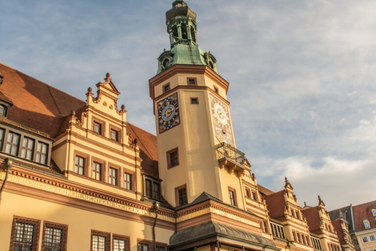 clock tower with town hall in yellow and orange when visiting leipzig germany