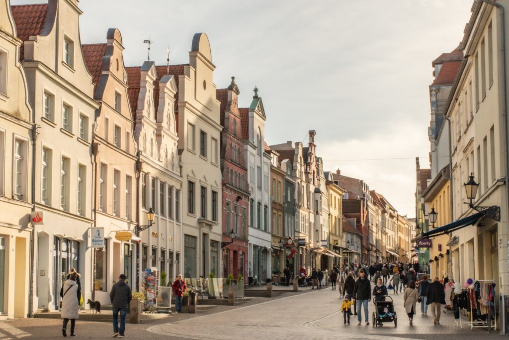 street in old town with buildings and people walking as one of the things to do in wismar germany