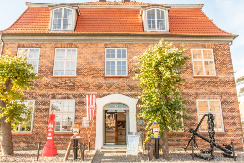 what to do in wismar germany, visit a museum in this red brick building with anchor