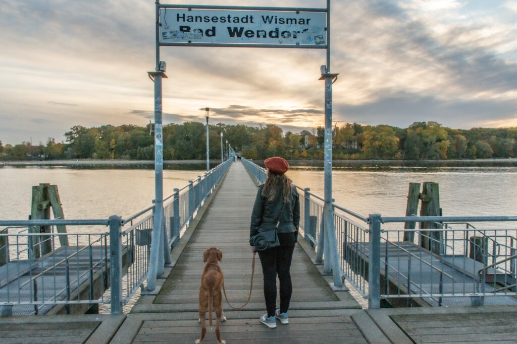girl with dog on pier as things to do in wismar germany