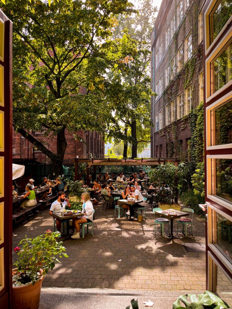 window to courtyard with tables and chairs at vegan brunch in berlin