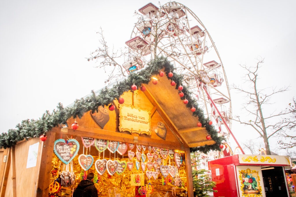 Ferris wheel, christmas market stall with sweets at berlin christmas market