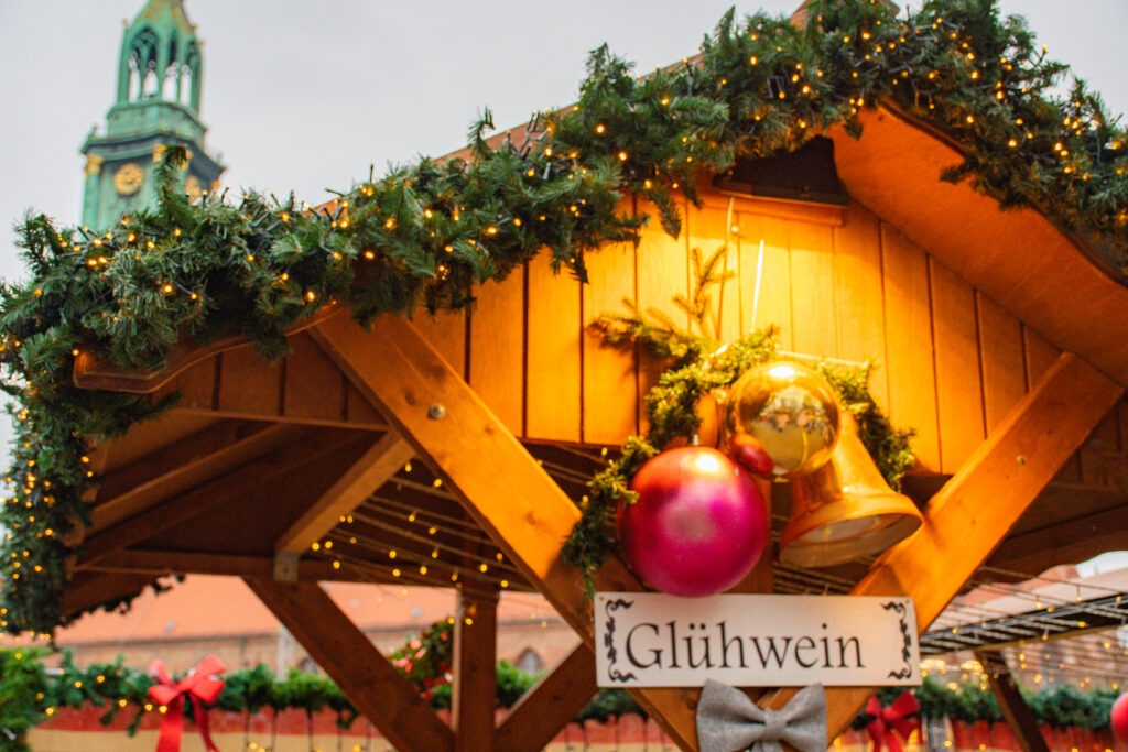 wooden stall at christmas in berlin with sign called gluhwein