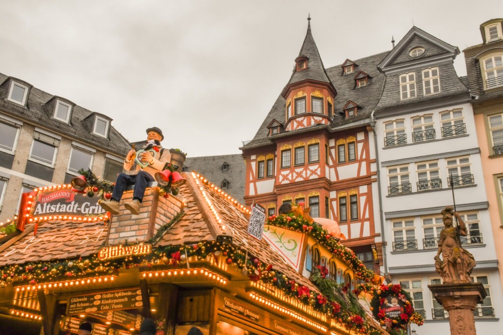 top of market stall with figurines and half timbered buildings at frankfurt christmas markets