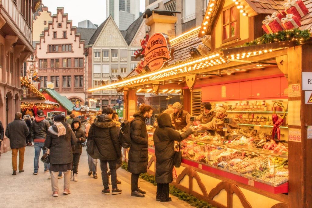 people at market stall at frankfurt christmas market 