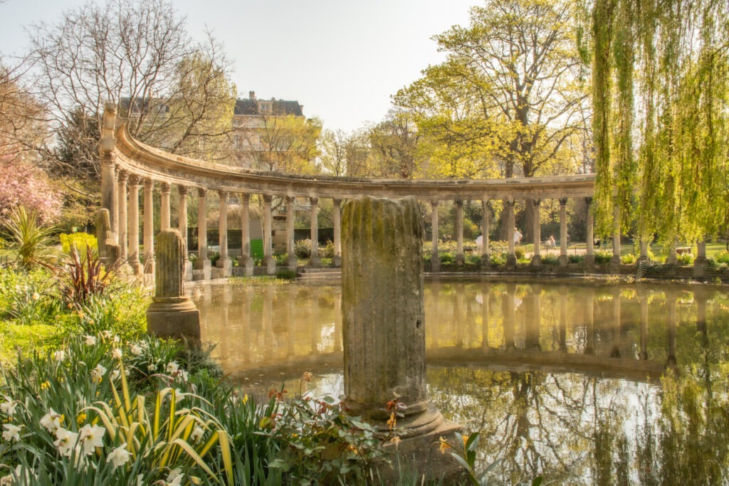 pond with ancient archway in park in paris and berlin comparison