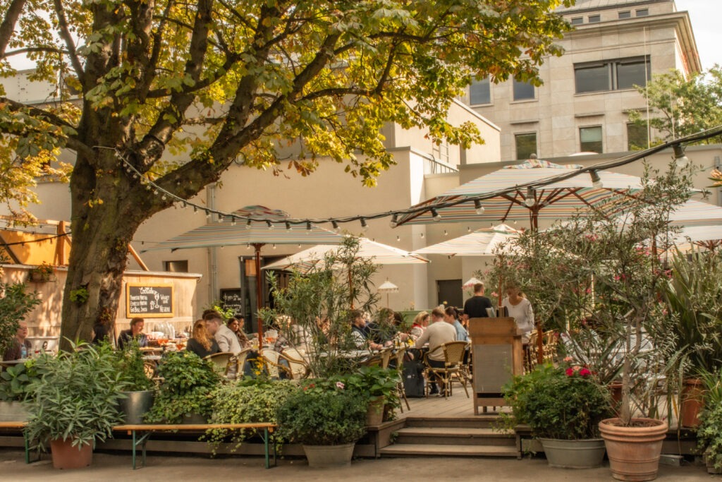 outdoor terrace at tiergarten restaurants with trees and umbrellas as tiergarten things to do