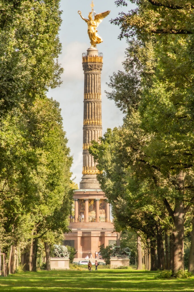 tall victory column with trees in tiergarten park in berlin