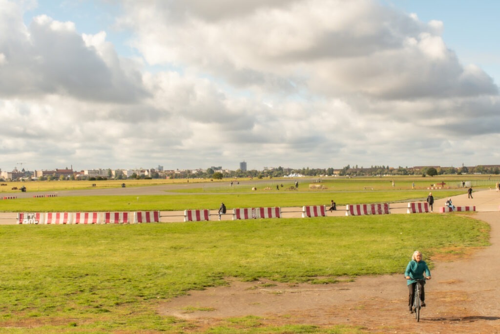 airfield with people walking, riding bikes in park berlin germany