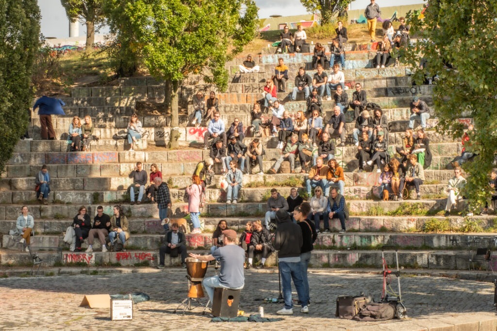 stone steps with people sitting listening to band in one of the best parks in berlin germany