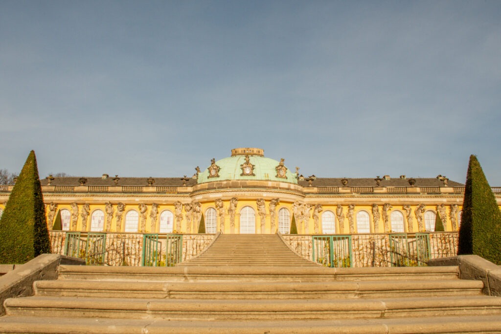 yellow palace with green copper roof in potsdam on one day trips from berlin by train