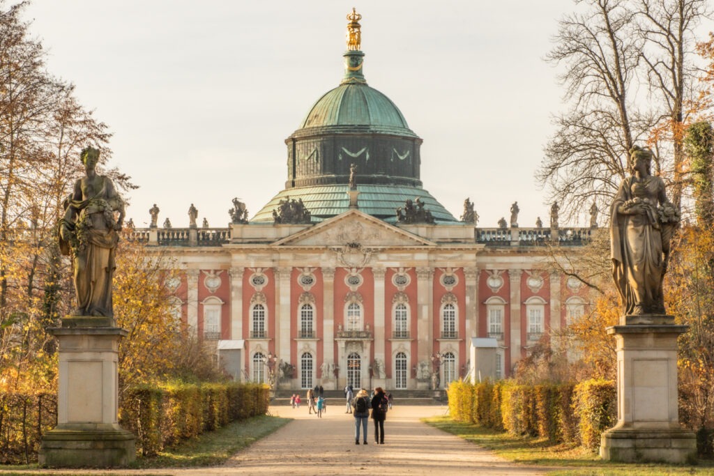 pink castle with green copper roof in potsdam on one day trip from berlin by train