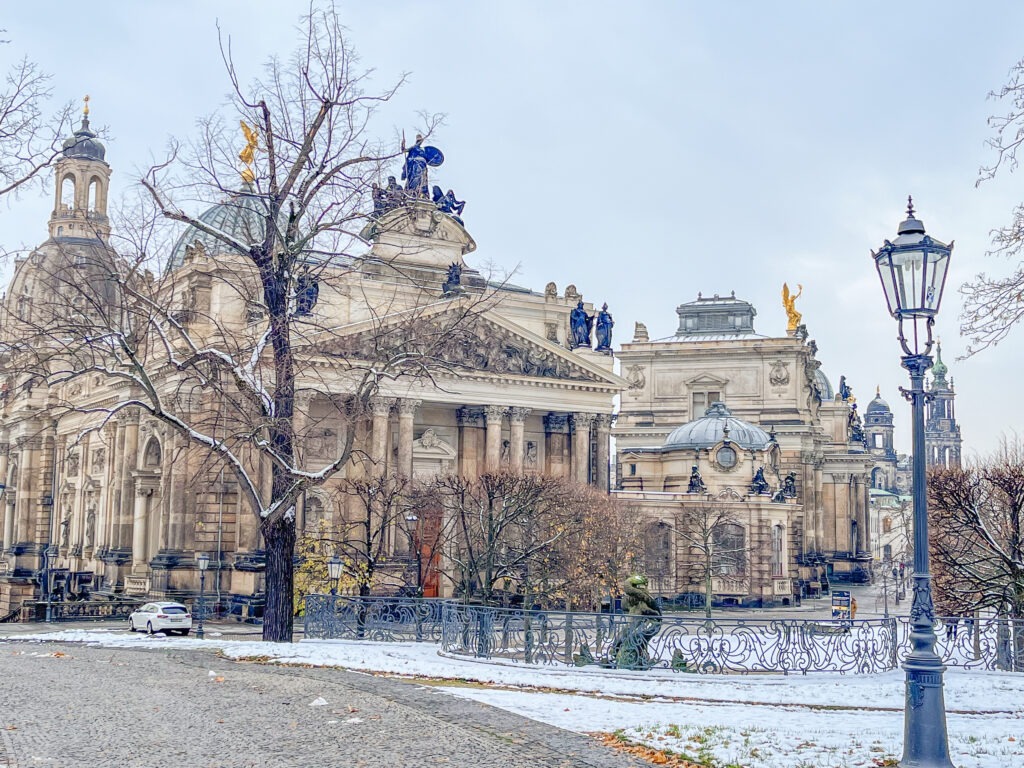 snow on ground with baroque building in dresden on one day trips from berlin 