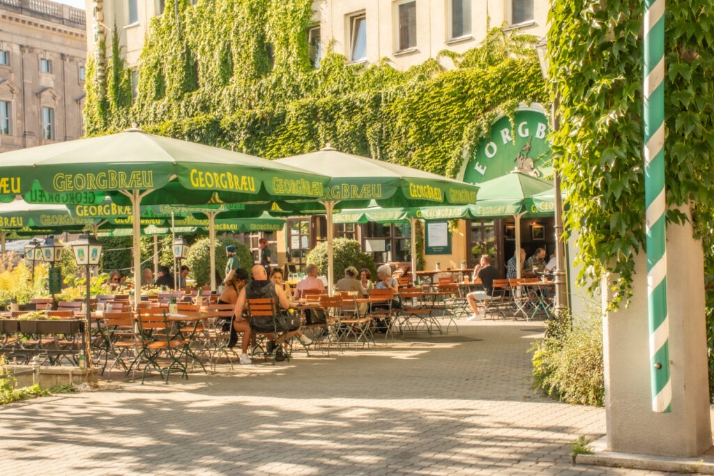 biergarten with tables and umbrellas as things to do in berlin in one day