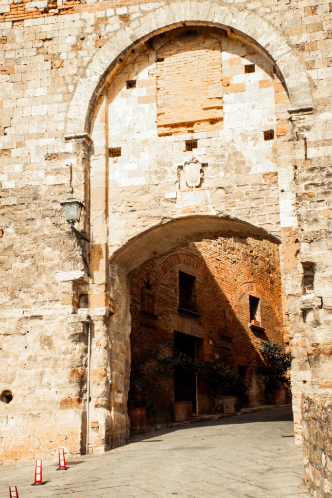stone walkway and archway as gate to montepulciano tuscany italy