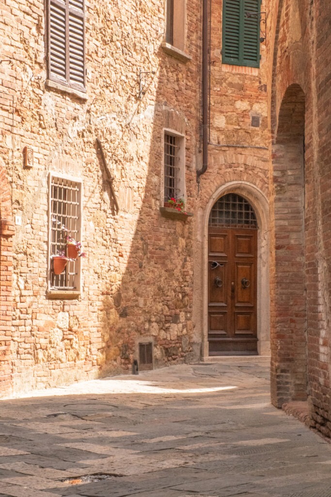 narrow street with door while wondering the streets of montepulciano