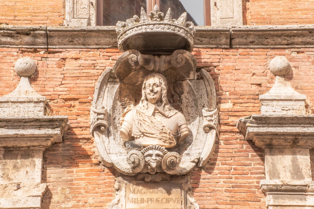 building with stone statue in montepulciano things to do