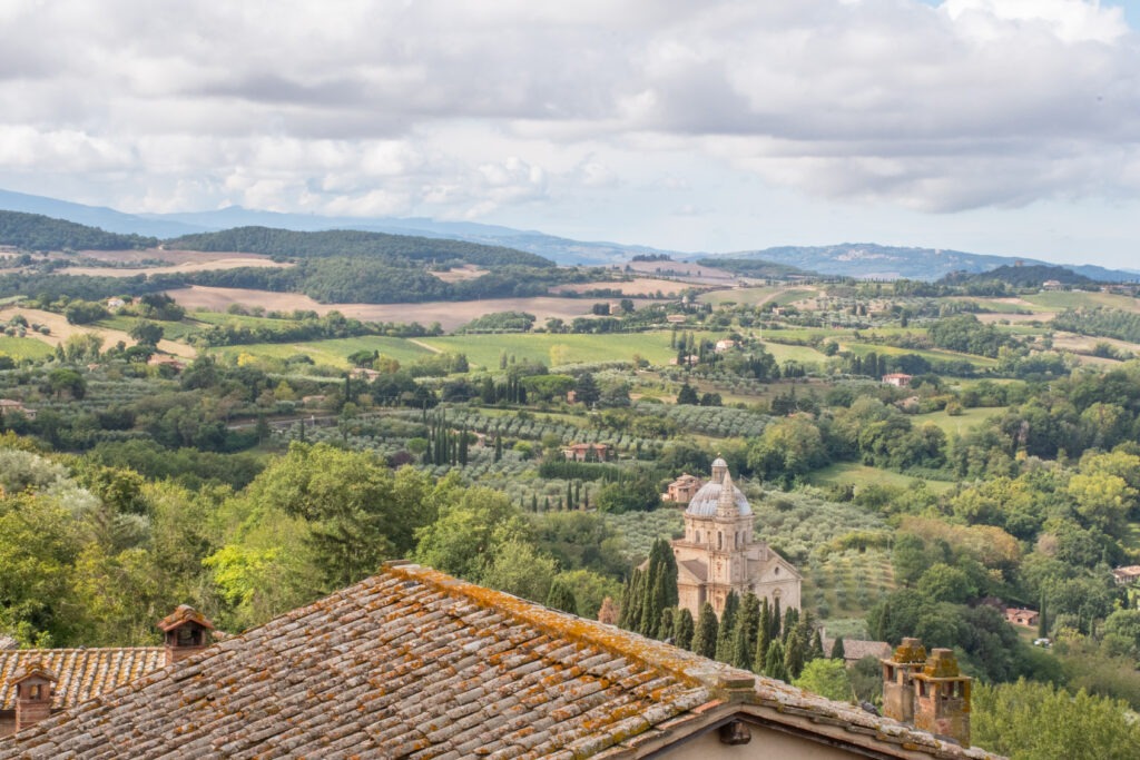 view to tuscany countryside with elegant church is one of the things to do in montepulciano