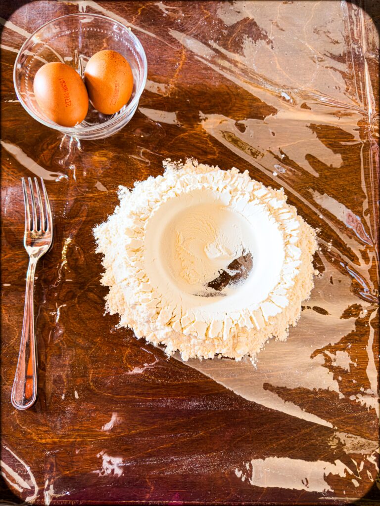 white flower shaped like a volcano with fork, and two eggs at a cooking class in verona