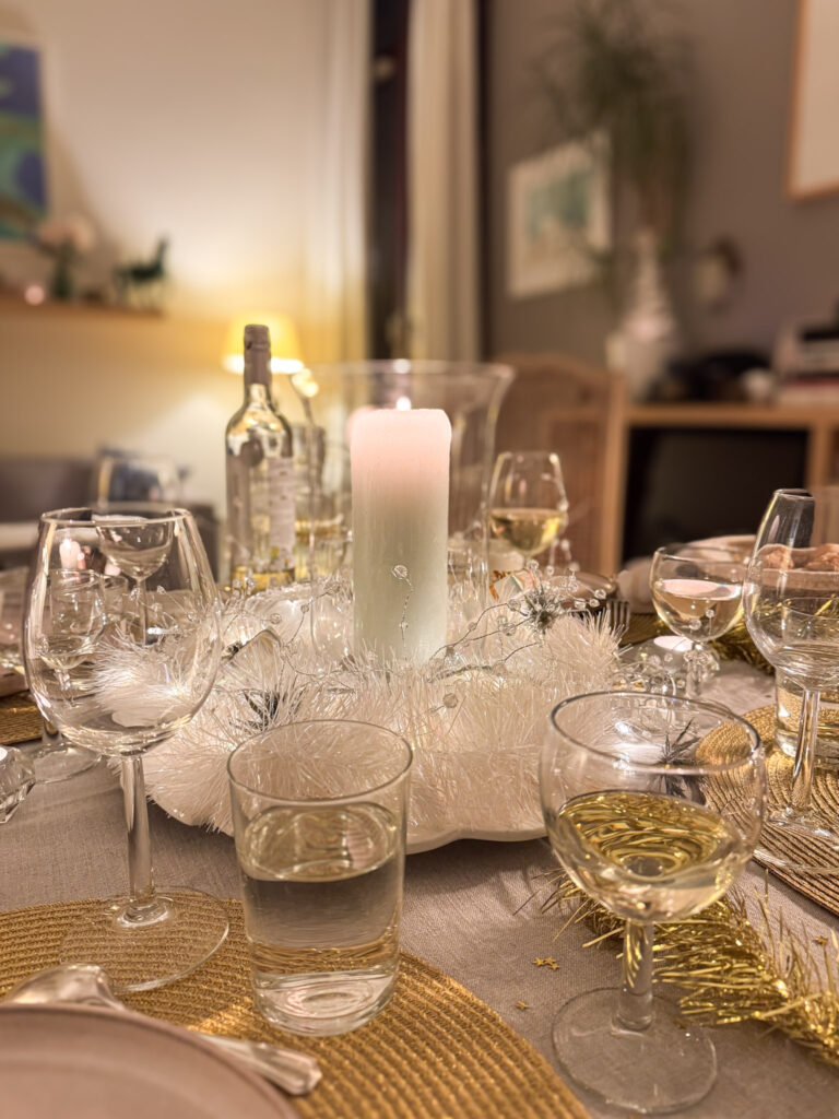 Is an Eatwith Paris Experience Worth It? 2 table scape at night showing glasses, candle centrepiece while at a Eatwith experience in Paris