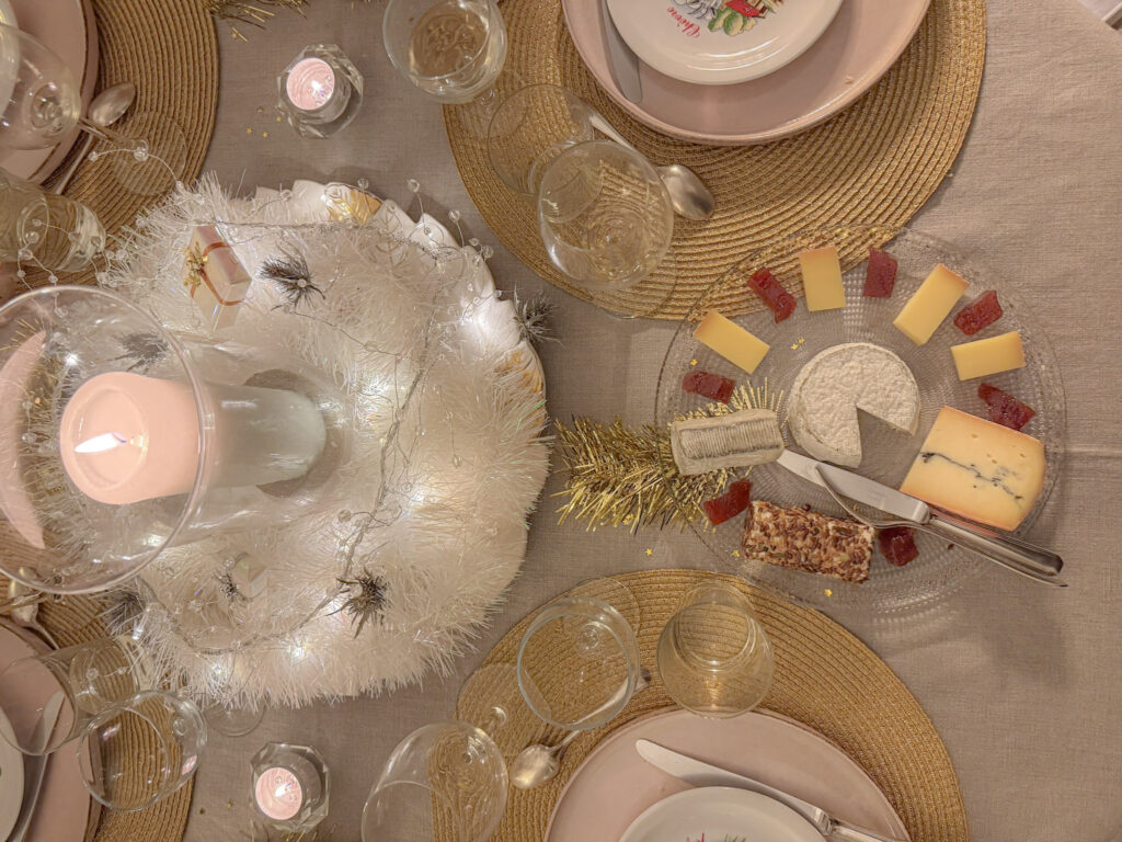 Is an Eatwith Paris Experience Worth It? 9 table scape at night showing glasses, candle centrepiece with a large cheese platter while at a Eatwith experience in Paris