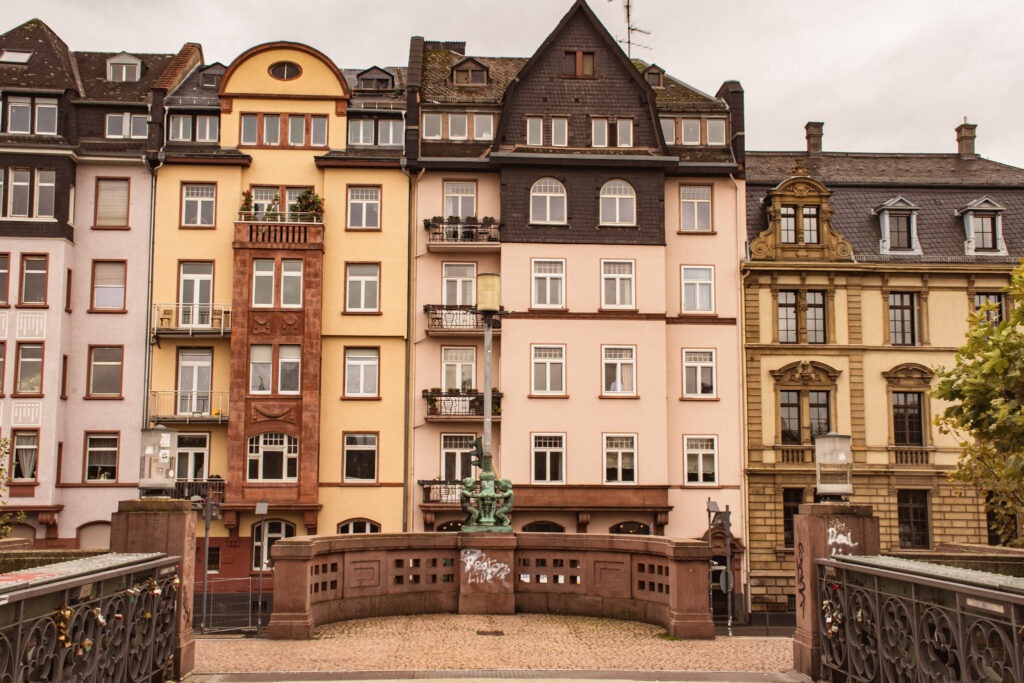 tall buildings in Frankfurt neighbourhood in pink, yellow and stone