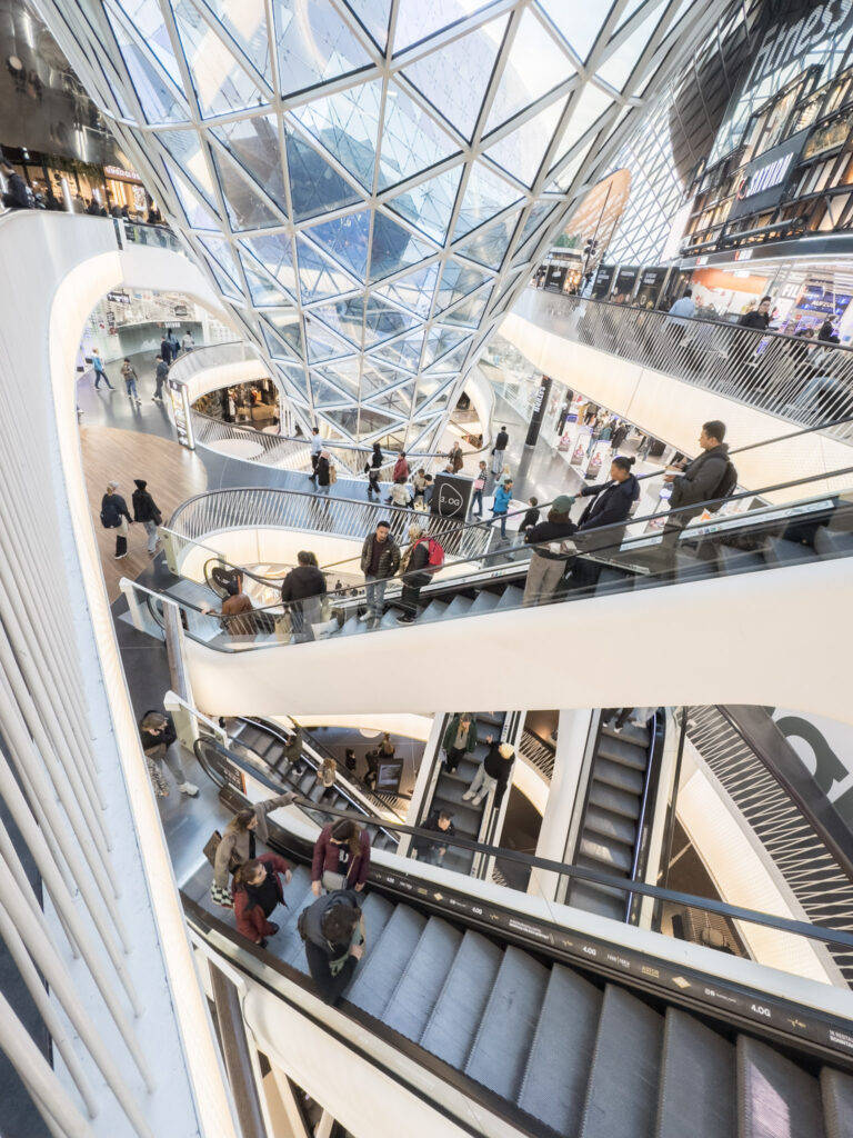 inside of shopping mall with modern architecture  with curved glass ceiling is a Frankfurt attraction