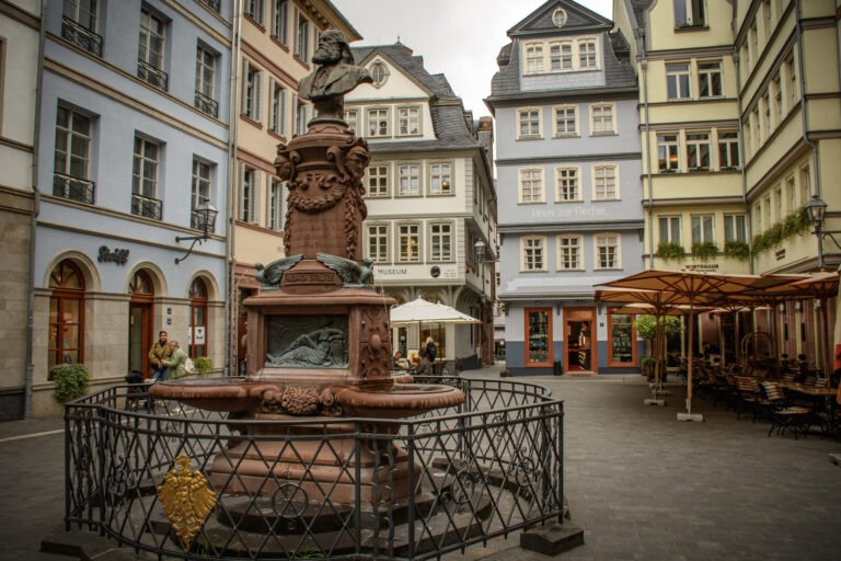 square in Frankfurt with colourful buildings and a statue in the middle while spending 7 days in Frankfurt